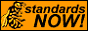 A wasp next to the words “standards NOW!”
